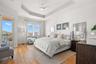 Main Bedroom Suite, featuring a large sitting area, king-size bed and access to the covered terrace.