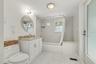 The updated downstairs bath pairs crisp finishes with a layout designed for comfortable everyday living.