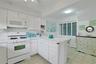 The doors here in the Kitchen go to the Laundry area which offers additional storage space as well.