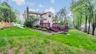 Rear view of house with a lawn, fence, a chimney, and a deck