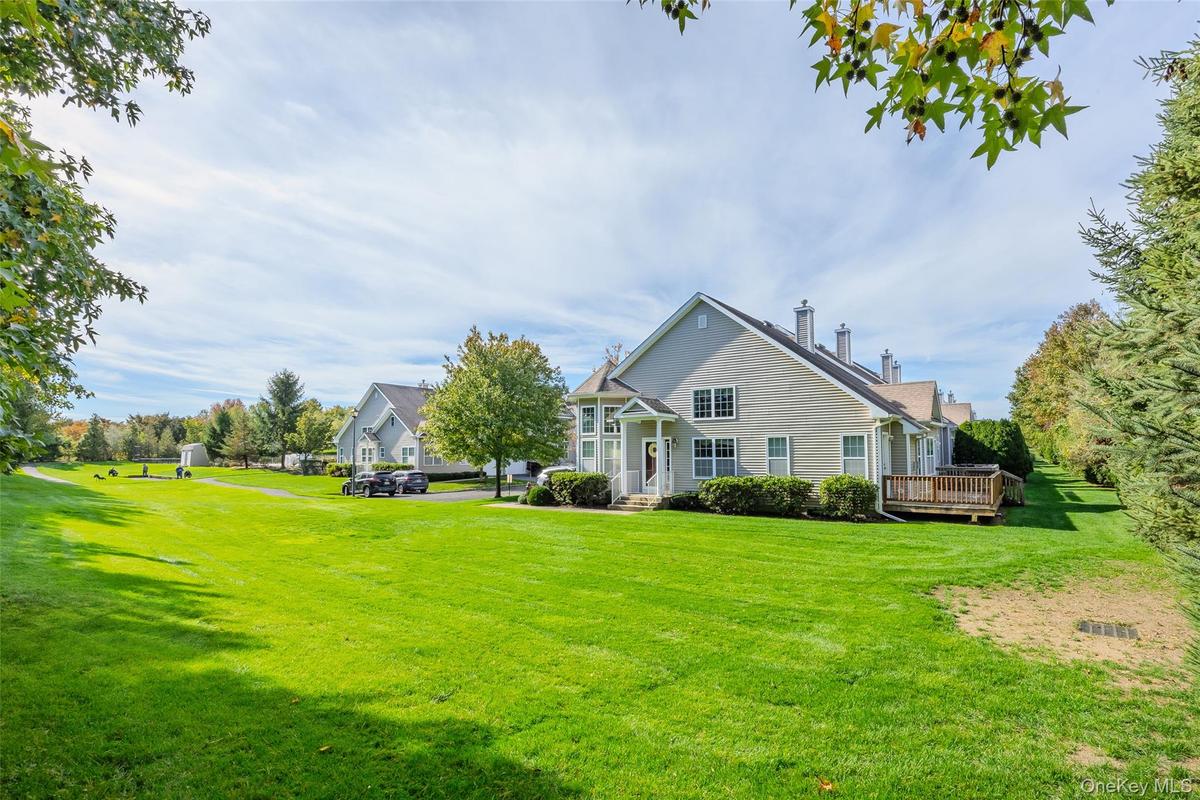 Rear view of property with a yard
