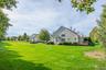 Rear view of property with a yard