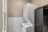 Stackable washer & dryer located next to the kitchen