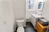 Bathroom featuring a white vanity with a rectangular sink, chrome faucet, and gray cabinetry