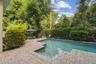 Private and lovely backyard view of the saltwater pool and one of the seating areas.