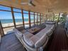 Sunroom featuring a water view, an outdoor hangout area, and ceiling fan