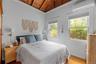 Bedroom featuring wooden ceiling, an AC wall unit, and wood finished floors
