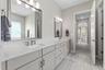 Dual sinks and oversized vanity along with a separate and private water closet.