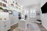 Custom shelving with built-in lighting brings this home office to life.