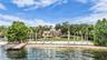 Sandy beach and dock with boat lift and 2 jet ski lifts