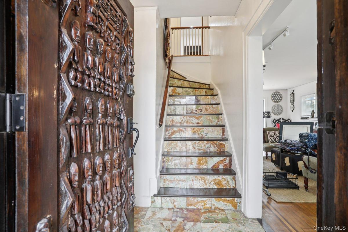 A beautiful sculpted door and artistic stair case
