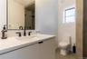 Full bathroom with vanity, an enclosed shower, and concrete floors