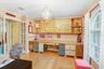 Unique custom cabinetry in home office which is off the front entry and includes hardwood floors and french doors leading to kitchen area.