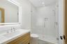 Bathroom featuring a shower stall and vanity