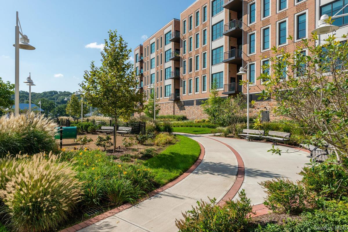 A beautifully landscaped on-mile Esplanade winds along the waterfront, framed by mature trees, lush shrubbery, and breathtaking water views.