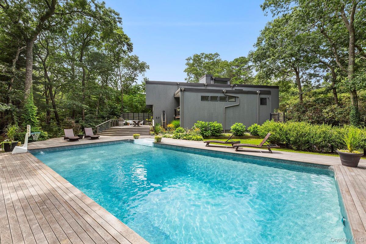 View of swimming pool with a wooden deck