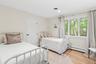 Bedroom featuring baseboard heating and light wood-style floors