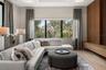 This exceptional space features a custom wood accent wall, oversized windows with tropical forest views, electric shades, direct sliding glass door ac