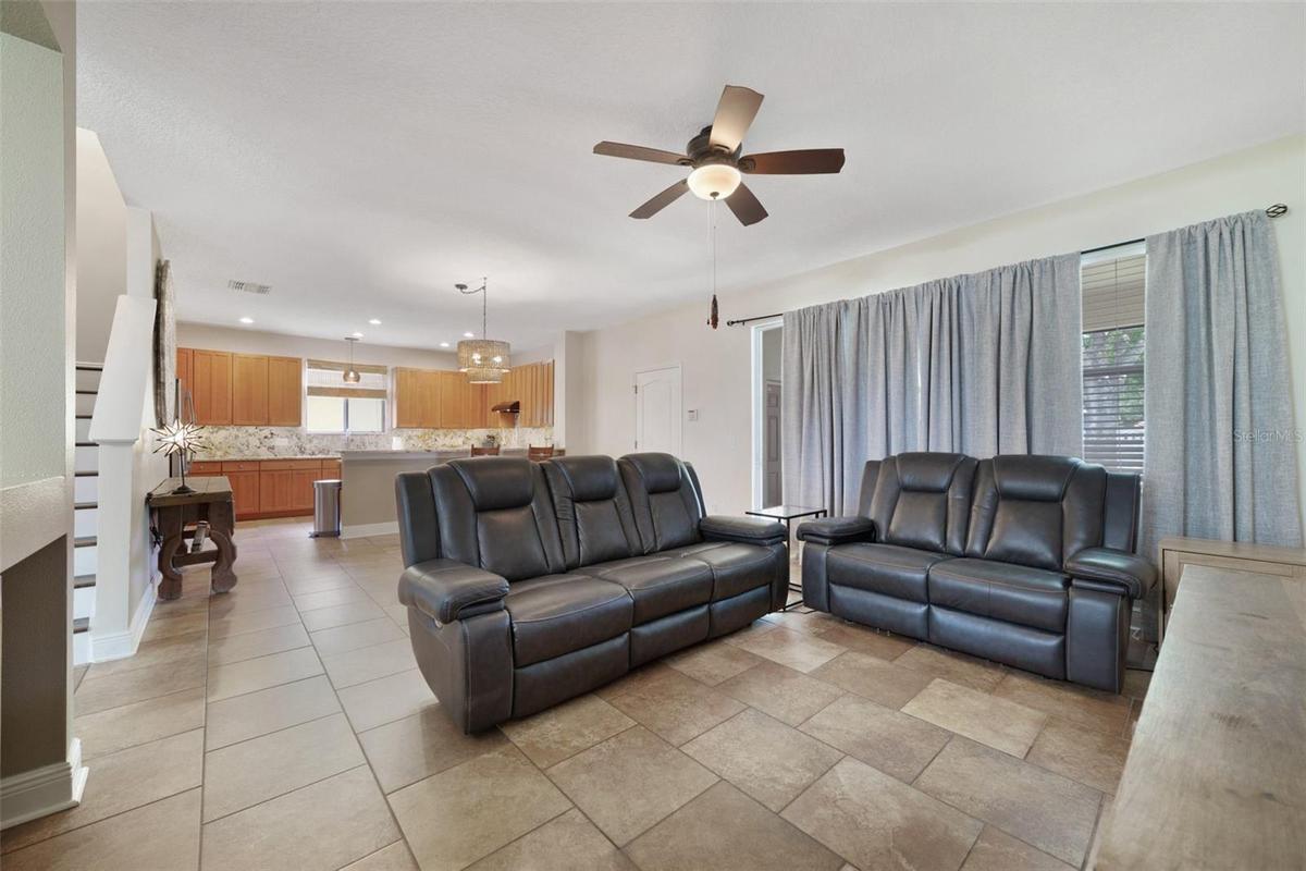 Family room is open to the kitchen with sliding glass doors that open to the screened lanai.