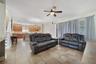 Family room is open to the kitchen with sliding glass doors that open to the screened lanai.