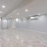 Finished basement with light marble finish floors, recessed lighting, and a wall mounted AC