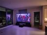 120” state-of-the-art projection TV at night that rises from the floor and a Sonos surround sound system.