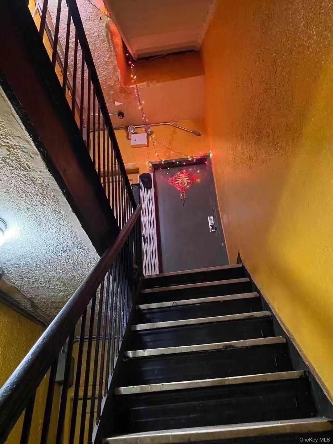 Staircase featuring a textured wall