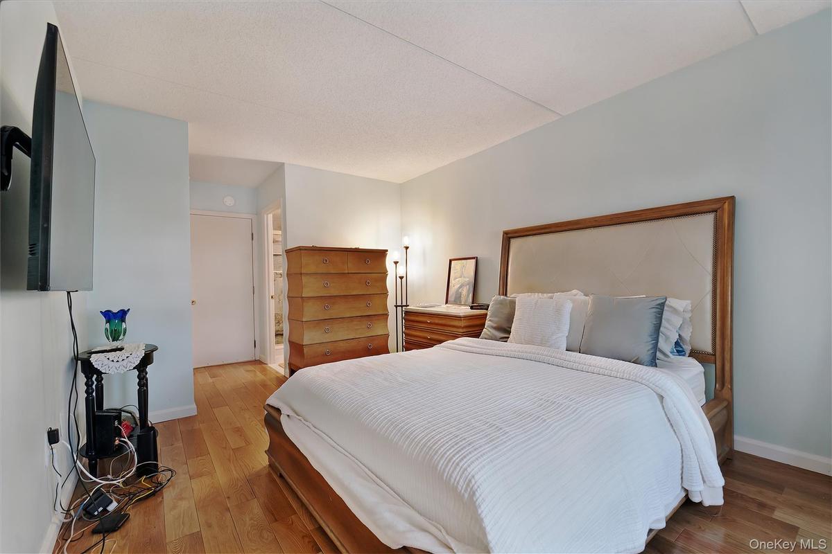 Light wood-finish flooring complements the pale blue wall paint