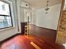 Empty room featuring wood finished floors, healthy amount of natural light, and ceiling fan