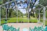 Serene private lakefront backyard with fruit trees, mature oaks, fire pit and floating dock.