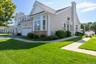 Charming single-family home featuring a brick and siding exterior with a peaked roofline and cupola