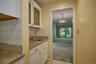 Separate area with a small sink and storage could be used as a bar area