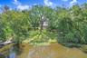 Drone view of back yard, floating dock and fire pit.