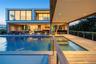 Swimming pool featuring an in-ground hot tub, a balcony, and a patio