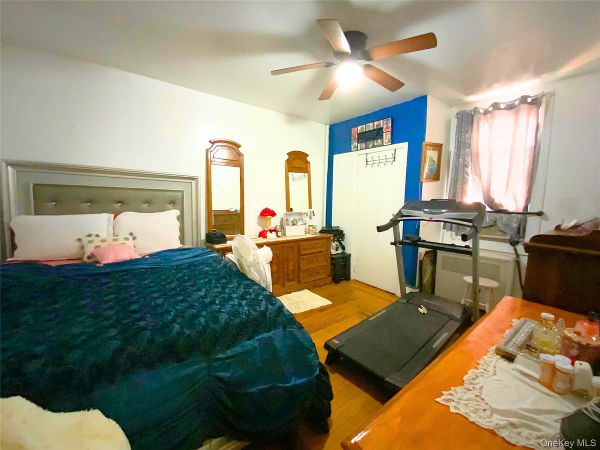 Bedroom featuring wood finished floors and ceiling fan