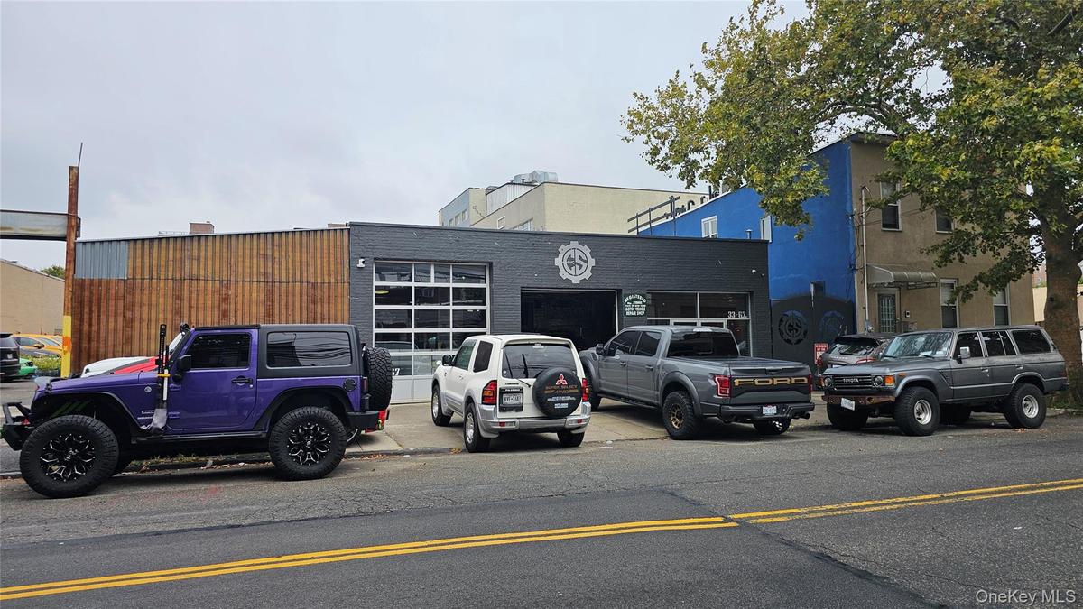 View of property with uncovered parking