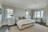 Bedroom featuring crown molding, multiple windows, and dark wood finished floors