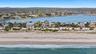 Aerial view featuring a water view and a beach view