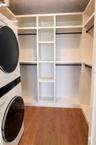 Primary Closet with a second washer & dryer set and custom shelving