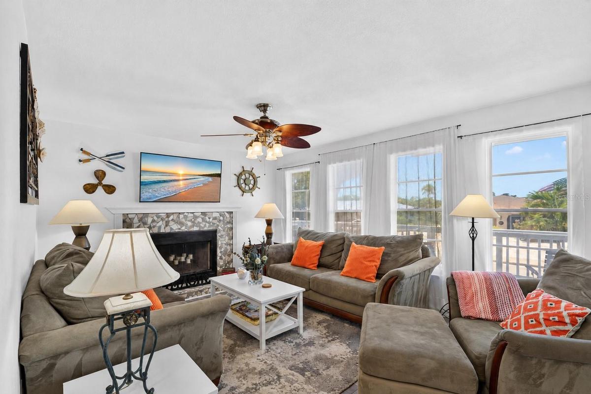 Bright living room with coastal décor, large windows, and abundant natural light.
