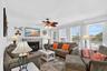 Bright living room with coastal décor, large windows, and abundant natural light.