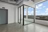 Unfurnished room with elevator, finished concrete flooring, and a city view