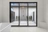 The sliding glass doors lead to the outdoor shower and private patio.