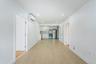 Hall featuring light wood finished floors, a wall mounted AC, and recessed lighting
