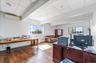 Office space featuring beam ceiling, hardwood / wood-style flooring, healthy amount of natural light, and a wall mounted air conditioner