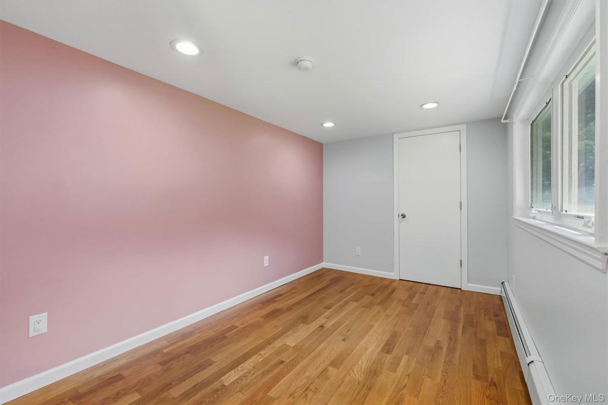 Office with hardwood  flooring with a matte finish, recessed lighting, and a white-trimmed window
