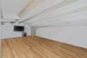 Unfurnished living room with light wood finished floors and beam ceiling