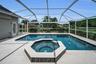 View of spa & pool and custom panoramic pool screen