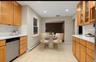 Kitchen featuring backsplash, a baseboard heating unit, stainless steel dishwasher, light countertops, and recessed lighting