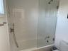 Full bathroom featuring toilet and combined bath / shower with glass door